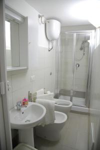 a bathroom with a toilet and a sink and a shower at Salerno Mare e Luci in Salerno