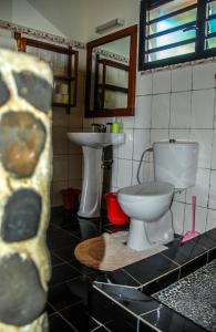 a bathroom with a toilet and a sink at Coucher de Soleil in Ambatoloaka