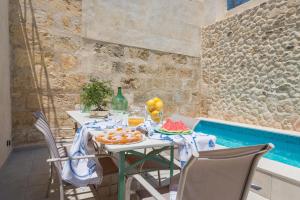 a table with fruit on it next to a pool at Can Diana in Campanet