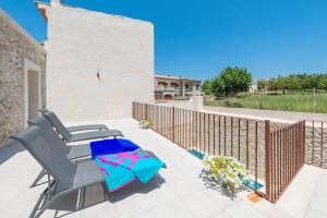 a patio with a table and a chair on a balcony at Can Diana in Campanet