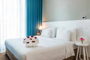 a bedroom with a white bed with a stuffed animal on it at Jannah Place Dubai Marina in Dubai +15 photos