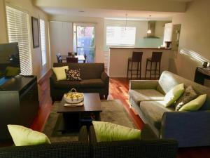 a living room with two couches and a table at Encore Apartments in Bathurst