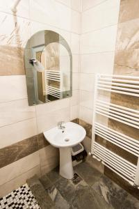 a bathroom with a sink and a mirror at Daiana Residence Turda in Turda