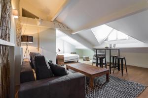 a living room with a couch and a table at Florella Jean Jaures Apartment in Cannes