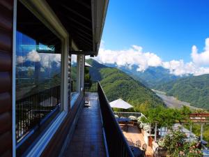 a balcony with a view of the mountains at 5 KM Villa in Renai