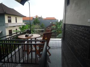 a balcony with a table and chairs on a balcony at Pratama house in Ubud