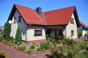 una casa con tetto rosso e giardino di Am Waldrand Spreewald a Burg