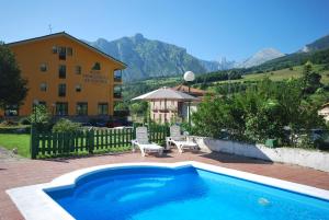 a swimming pool in front of a building at Hotel Principado De Europa in Arenas de Cabrales