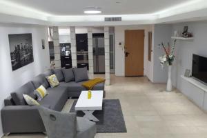 a living room with a couch and a table at Sweethome26 EILAT Apt with Jaccuzzi / Free Parking in Eilat