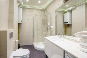 a bathroom with a toilet and a sink and a shower at Apart Madryt in Tarnobrzeg +52 photos