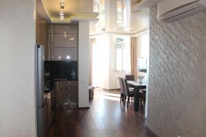 a kitchen and dining room with a table and a dining room at Gorgiladze Seaside Apartment in Batumi