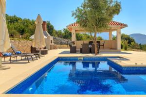 a swimming pool with a patio and a gazebo at Hedera Estate, Villa Hedera VII in Zaton