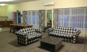 a living room filled with furniture and a couch at Avalon Motel in Mount Gambier