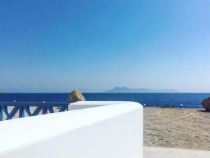 a white fence on the beach near the ocean at Alisachni Villas in Lefkos Karpathou