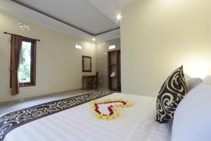 Postel nebo postele na pokoji v ubytování Pondok Mundeh Ubud