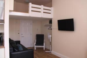 a living room with a couch and a loft bed at The Trafford in Stockport