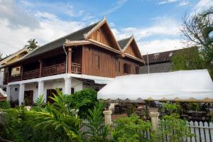 a wooden house with a white fence in front of it at Cold River in Luang Prabang