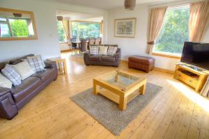 a living room with a couch and a coffee table at ArdFyne on Lochfyne in Strachur