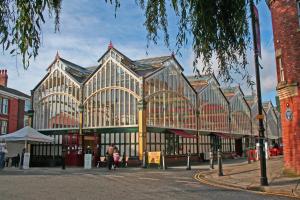 a large building with people sitting in front of it at The Manchester in Stockport