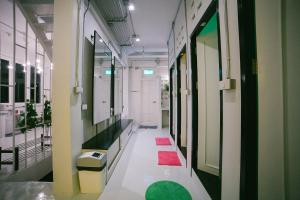 a hallway of a hospital with red and green rugs at Diff Hostel in Bangkok