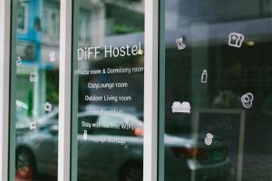 a glass door with a sign that says gift hostel at Diff Hostel in Bangkok