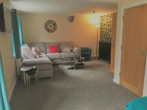 a living room with a couch and a table at Stratford House in Stratford-upon-Avon