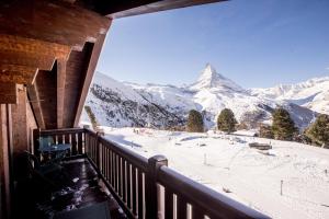 a balcony with a view of a snow covered mountain at Riffelalp Resort 2222m in Zermatt