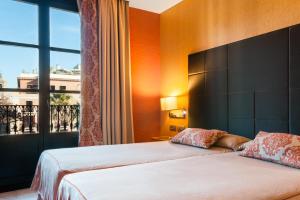 מיטה או מיטות בחדר ב-Hotel Medinaceli
