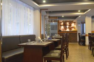 a restaurant with tables and chairs and a bar at Jagjeet's Sikkim Retreat in Gangtok