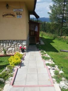 a walkway outside of a house with a building at Willa Pośrednia in Zakopane