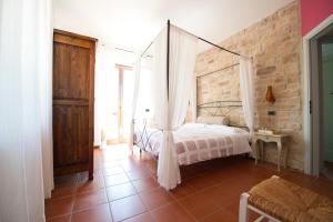 Postel nebo postele na pokoji v ubytování Agriturismo La Corte del Lupo