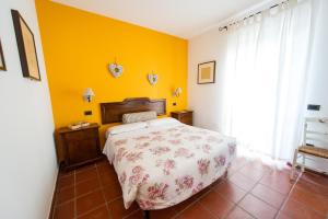 Postel nebo postele na pokoji v ubytování Agriturismo La Corte del Lupo