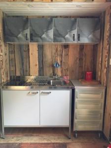 a kitchen with a sink and a stove at Storbo Adventure Camp in Storbo