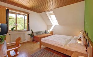a bedroom with a bed and a couch and a window at Birkenhof Loipersdorf in Loipersdorf bei Fürstenfeld +39 photos