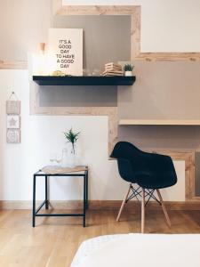 a black chair and a table in a room at KL Gateway Residency in Kuala Lumpur
