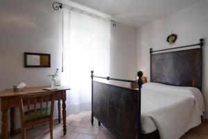 Postel nebo postele na pokoji v ubytování Agriturismo Maso Lizzone