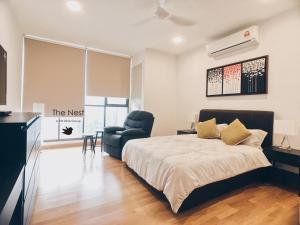 a bedroom with a bed and a chair at KL Gateway Residency in Kuala Lumpur
