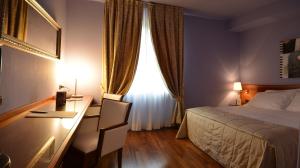 Letto o letti in una camera di Albergo Celide