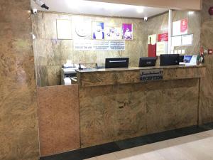 a lobby with a reception counter in a building at Simba Hotel in Dubai