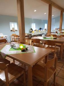 a dining room with wooden tables and chairs at Herberge-Wichernhaus-Boltenhagen in Boltenhagen +9 photos