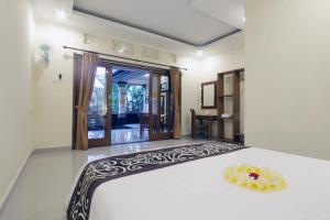 Postel nebo postele na pokoji v ubytování Pondok Mundeh Ubud