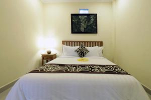 Postel nebo postele na pokoji v ubytování Pondok Mundeh Ubud