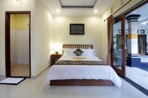 Postel nebo postele na pokoji v ubytování Pondok Mundeh Ubud