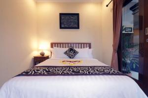Postel nebo postele na pokoji v ubytování Pondok Mundeh Ubud