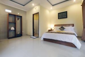 Postel nebo postele na pokoji v ubytování Pondok Mundeh Ubud