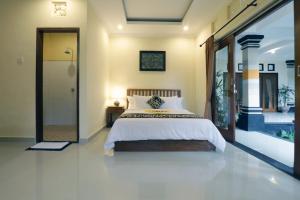 Postel nebo postele na pokoji v ubytování Pondok Mundeh Ubud
