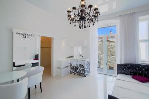 a living room with a chandelier and a dining room at Collins Apartments Center in Pula