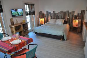 a bedroom with a bed and a table and chairs at cal erre in Céret