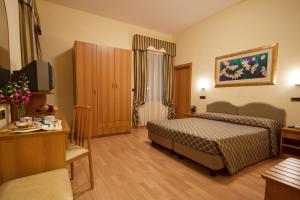 Postel nebo postele na pokoji v ubytování Hotel Villa Luca