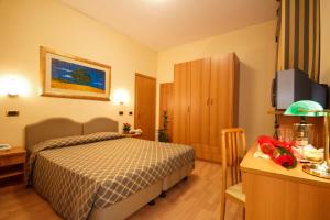 Postel nebo postele na pokoji v ubytování Hotel Villa Luca